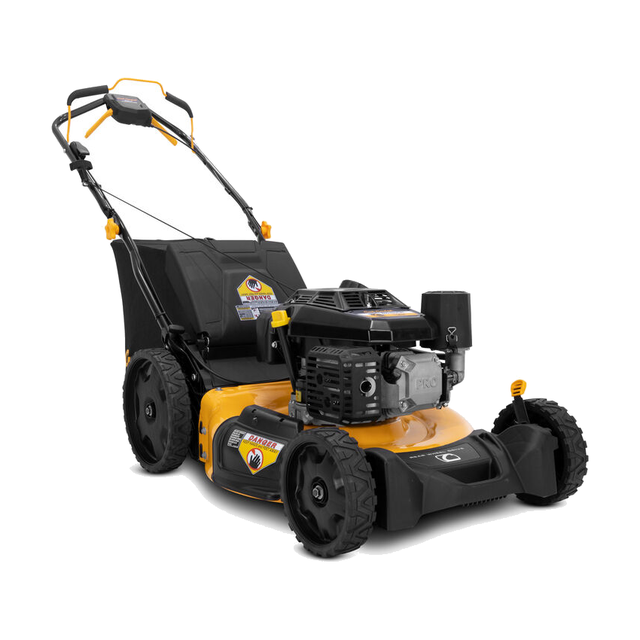 Cub Cadet SC500K walk-behind lawn mower with grass bag and folding handle on a mowed lawn.